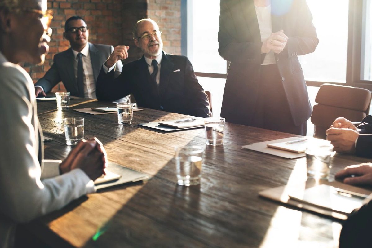 A group of people sitting at a table talking.